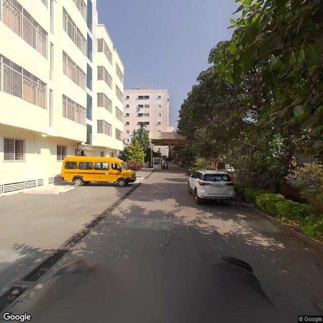 The frontage road, along the school wall