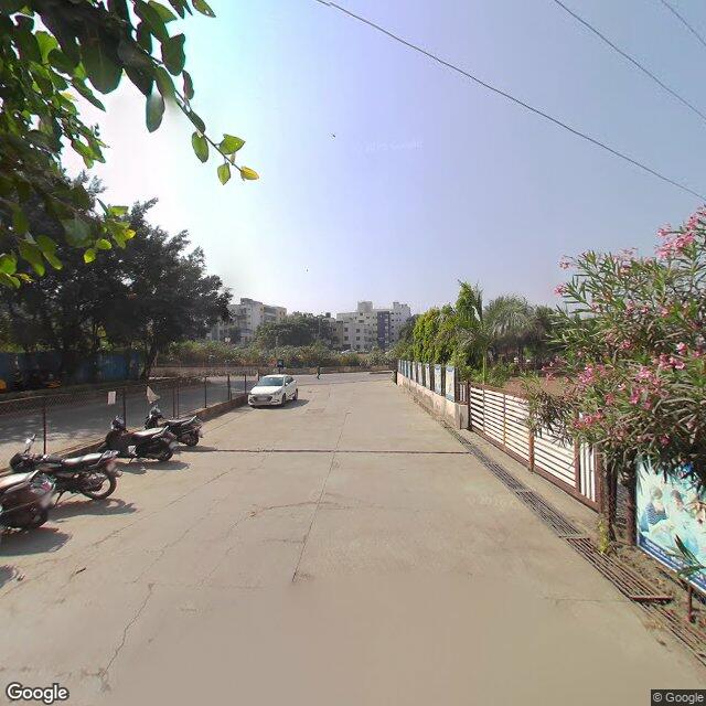 The frontage road, along the school wall