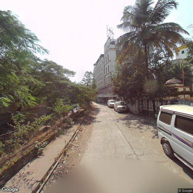 Along the street, away from the gate