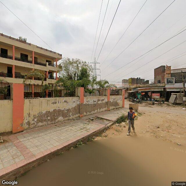 The frontage road, along the school wall