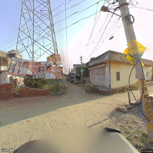 Along the street, away from the gate