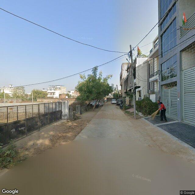 Along the street, away from the gate