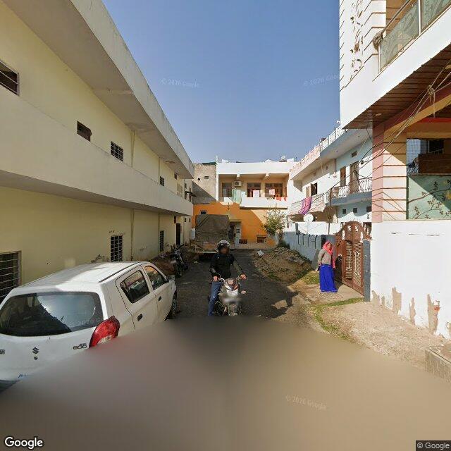 Along the street, away from the gate