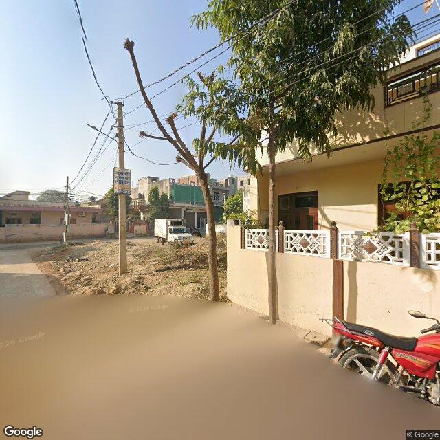 The frontage road, along the school wall
