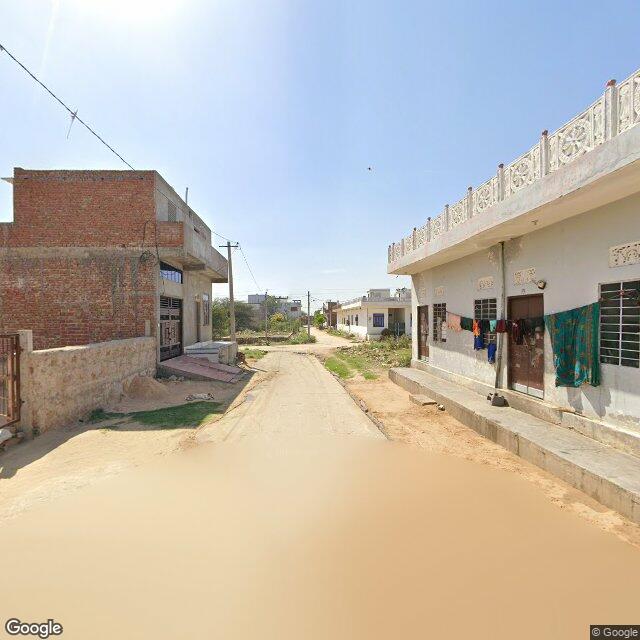Along the street, away from the gate