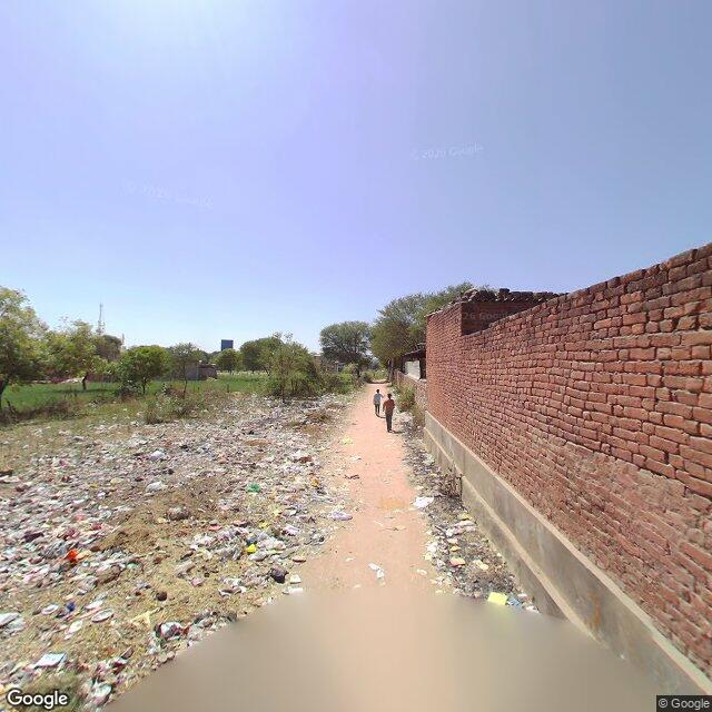 The frontage road, along the school wall