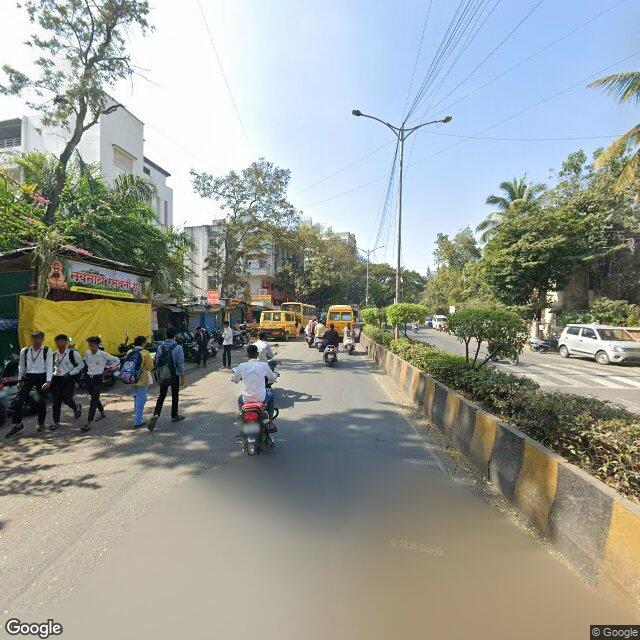 The frontage road, along the school wall