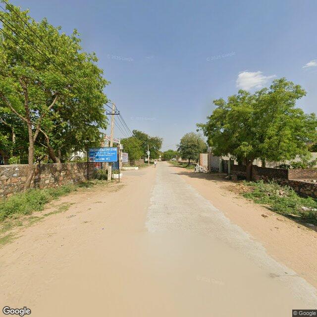 Along the street, away from the gate