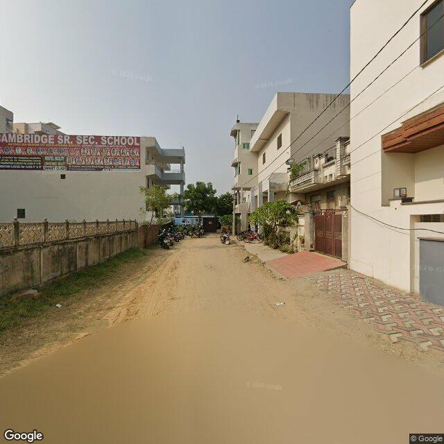 Along the street, away from the gate