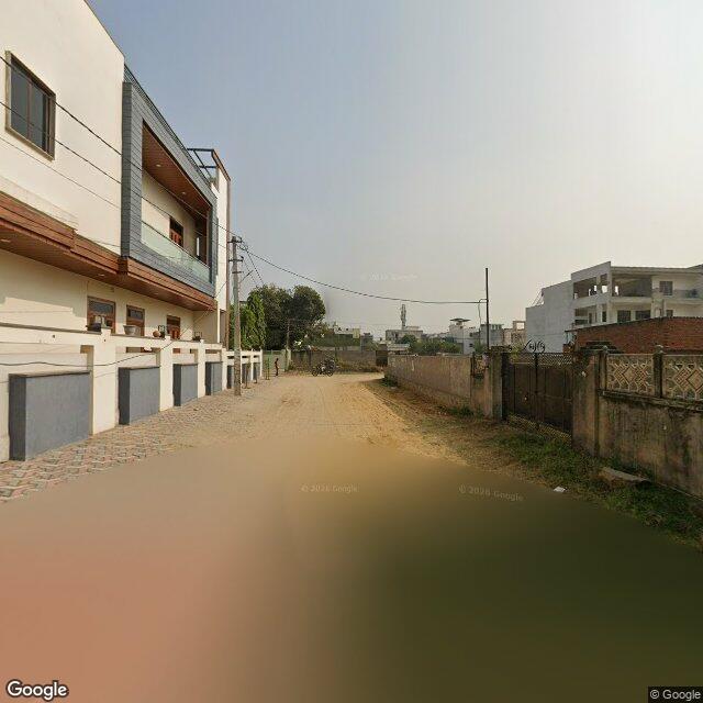 The frontage road, along the school wall