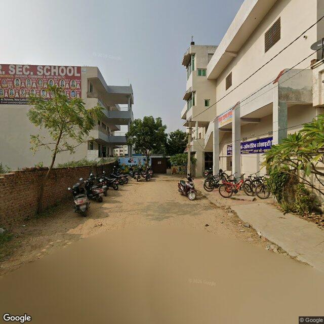 The frontage road, along the school wall