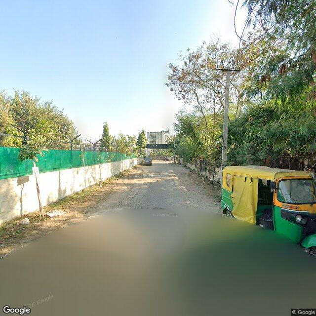 Along the street, away from the gate