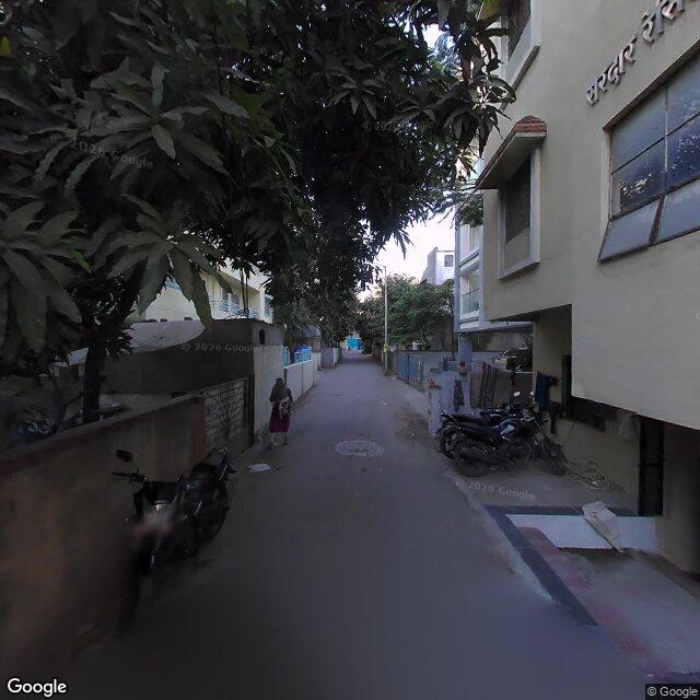 Along the street, away from the gate