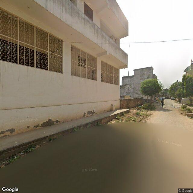 The frontage road, along the school wall