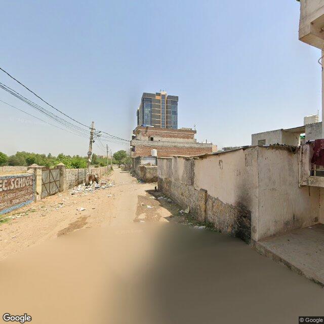 The frontage road, along the school wall