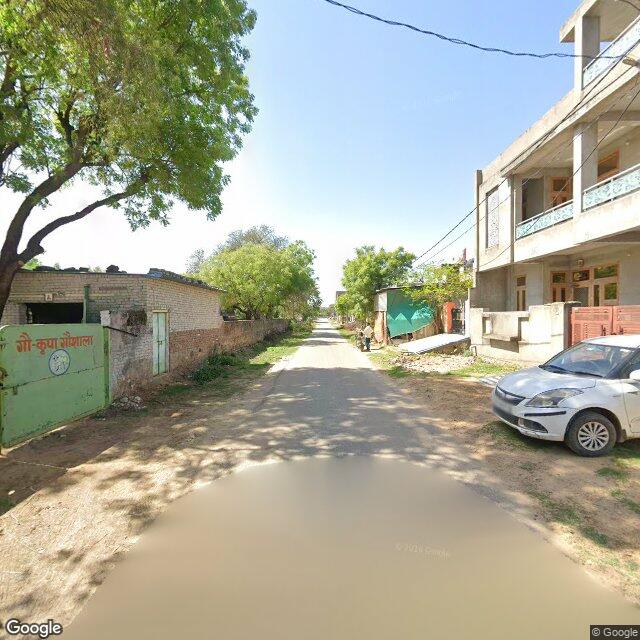 Along the street, away from the gate