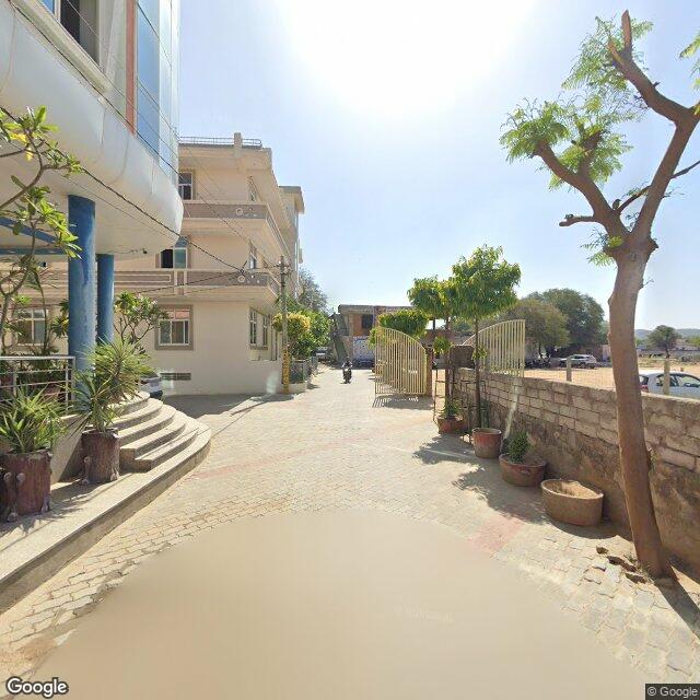 Along the street, away from the gate