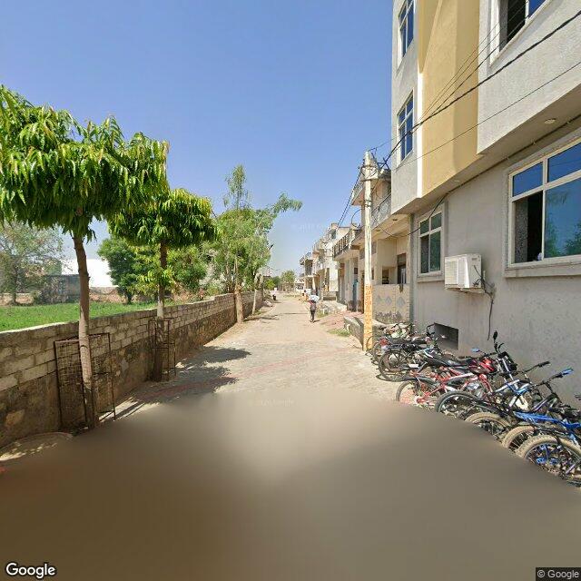 Along the street, away from the gate