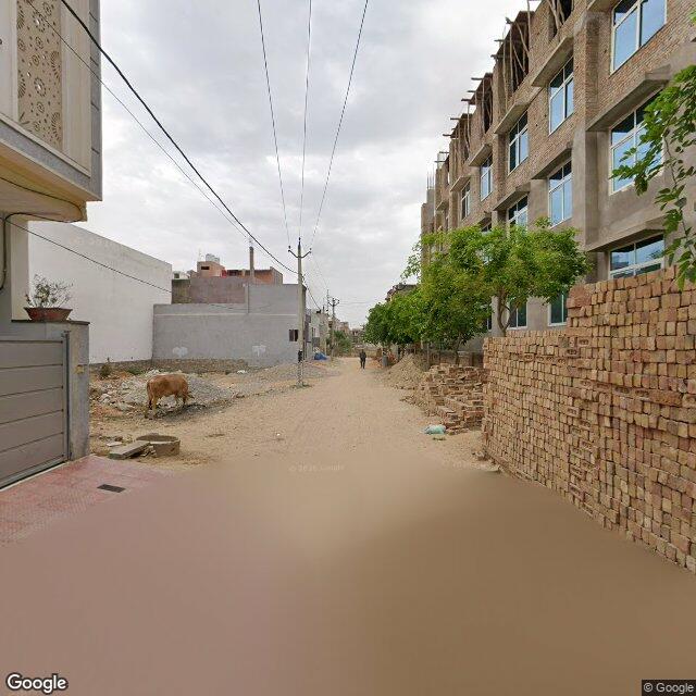 Along the street, away from the gate