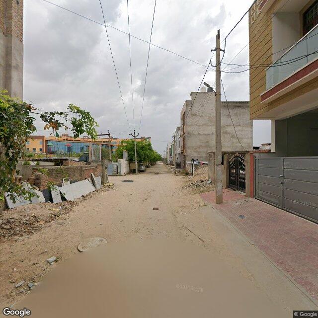 Along the street, away from the gate
