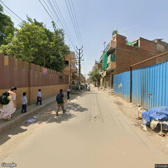 Along the street, away from the gate