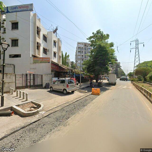 Along the street, away from the gate