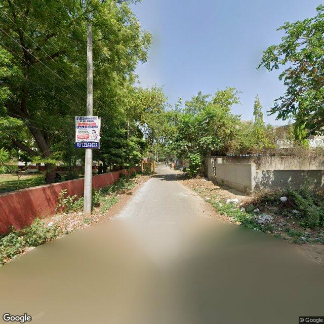 Along the street, away from the gate
