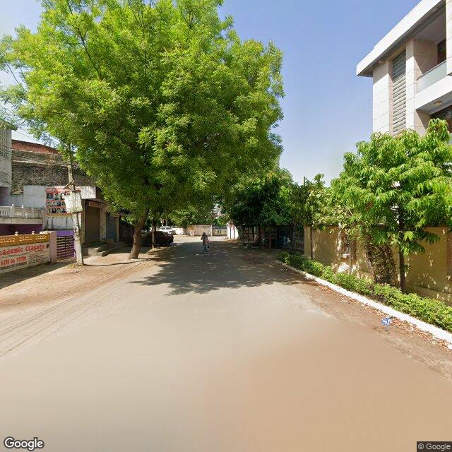 Along the street, away from the gate