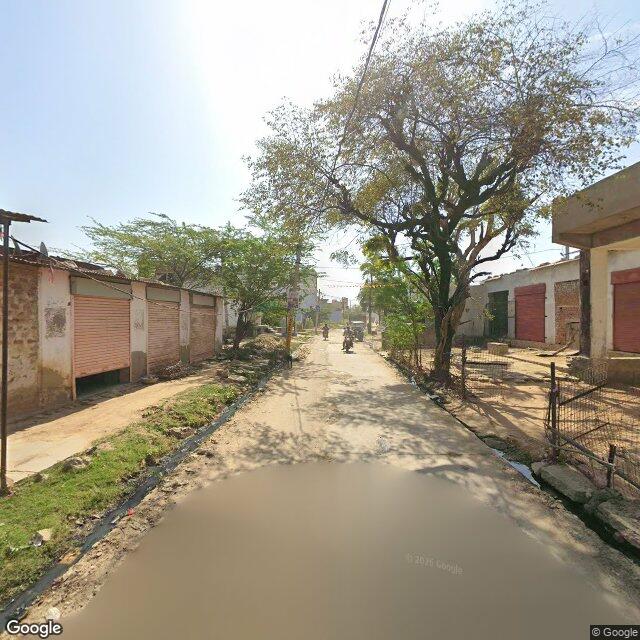 The frontage road, along the school wall