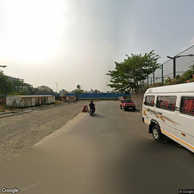 The frontage road, along the school wall