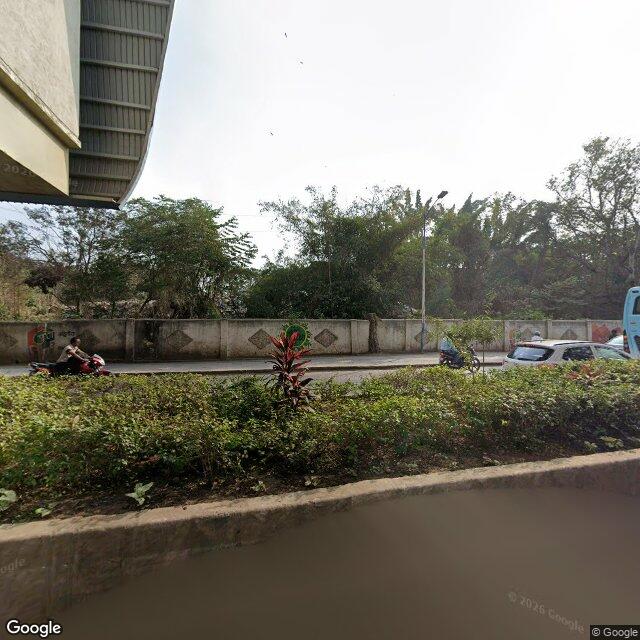 The frontage road, along the school wall