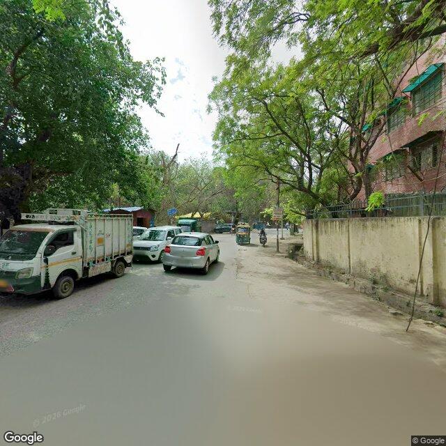 Along the street, away from the gate