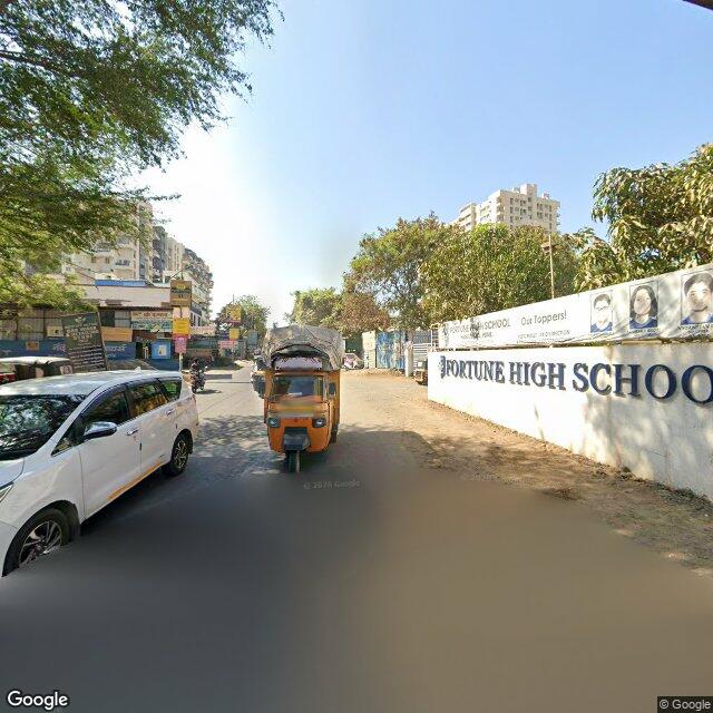 The frontage road, along the school wall