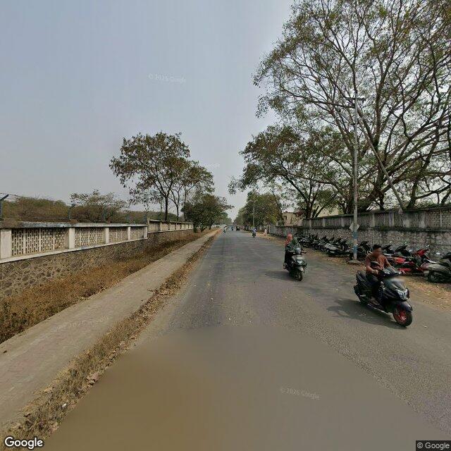 The frontage road, along the school wall