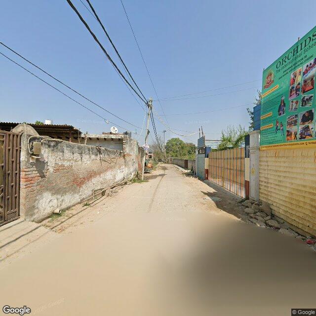 Along the street, away from the gate