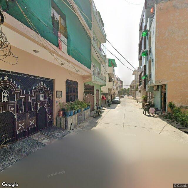 Along the street, away from the gate