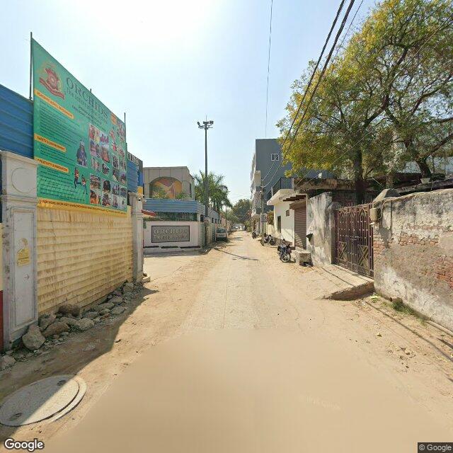 Along the street, away from the gate
