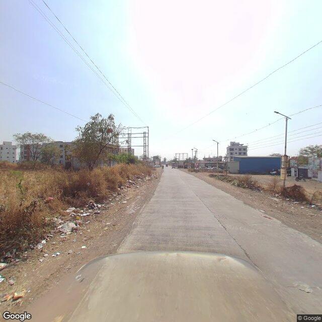 Along the street, away from the gate